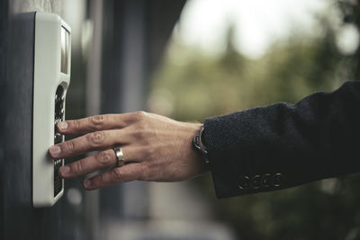 Cropped image of businessman's hand entering security code
