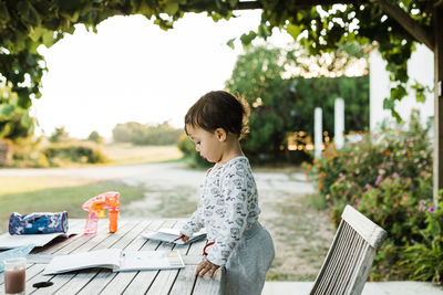 Side view of woman sitting on table