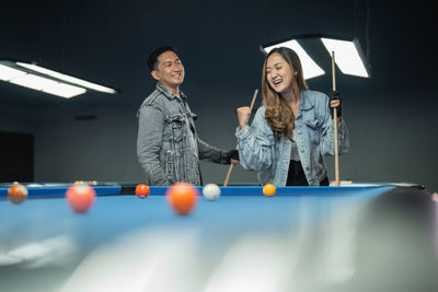 Young woman playing pool