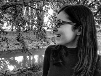 Portrait of girl looking away against trees