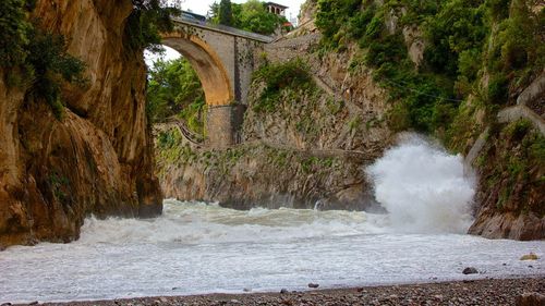 Scenic view of river flowing through bridge