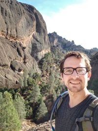 Portrait of smiling young man in mountains