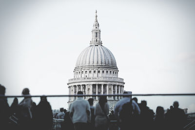 Rear view of people against domed structure