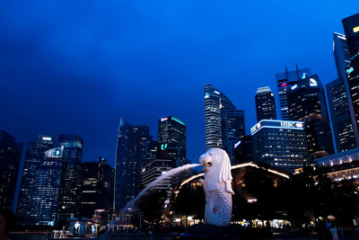 Rear view of woman standing in city at night