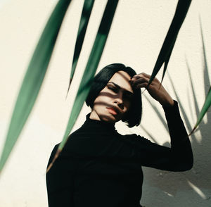 Low angle view of woman standing against wall