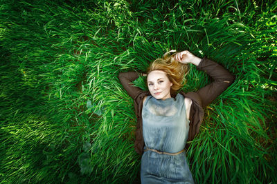 Directly above shot of woman lying on grass