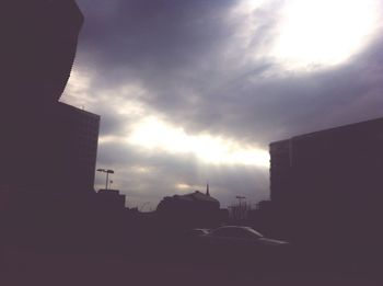 Silhouette of buildings against sky during sunset