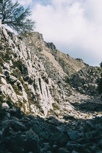 Low angle view of rock formations against sky