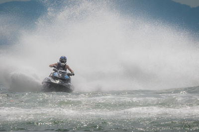 Man riding motorcycle on sea