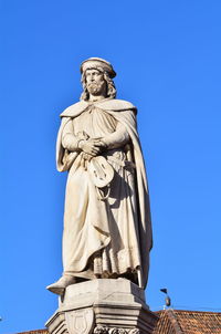 Low angle view of statue against blue sky