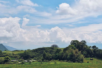 Scenic view of field against cloudy sky