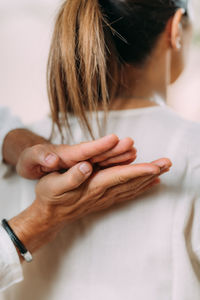 Woman enjoying shiatsu back massage, sitting on the shiatsu massage mat.