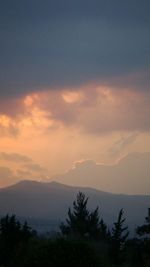 Scenic view of mountains against cloudy sky