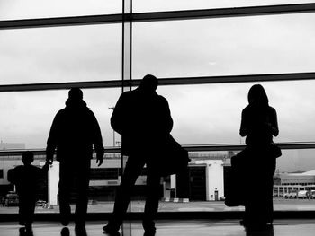 Rear view of silhouette people at airport