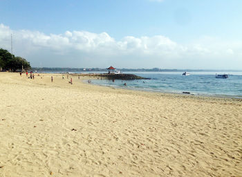 View of beach against cloudy sky