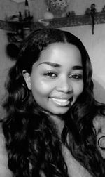 Close-up portrait of smiling young woman in store