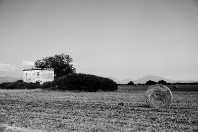 Hay bale on field against sky