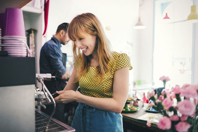 Young woman holding while standing at home