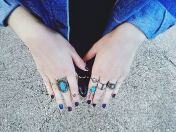 Low section of woman wearing rings on road