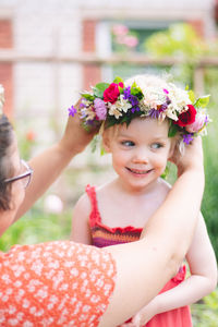 Portrait of happy girl with pink flower