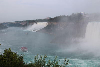 Panoramic view of waterfall against sky