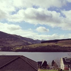 Houses by mountains against sky