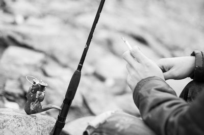 Close-up of hand holding cigarette