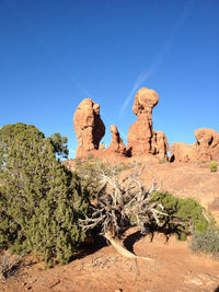 Scenic view of rock formations against clear blue sky