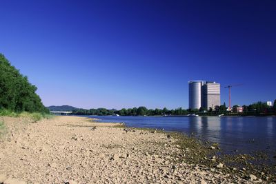 Scenic view of lake against clear blue sky