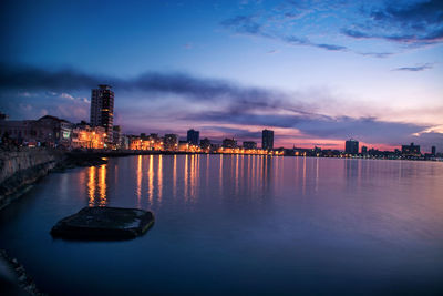 Reflection of illuminated buildings in calm water