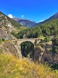 Arch bridge over river against sky