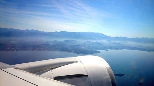 Close-up of airplane wing against sky