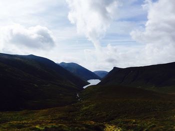 Scenic view of mountains against cloudy sky
