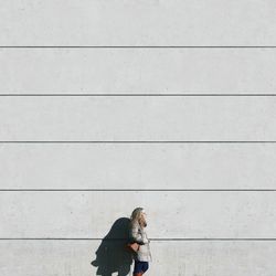 Woman standing against wall