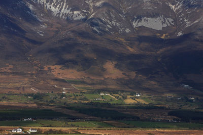 Scenic view of field and mountains against sky