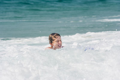 High angle view of man swimming in sea