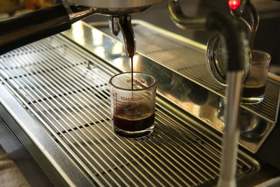 Close-up of coffee pouring in glass