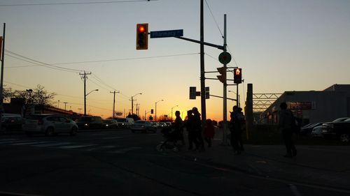 Traffic on road at sunset