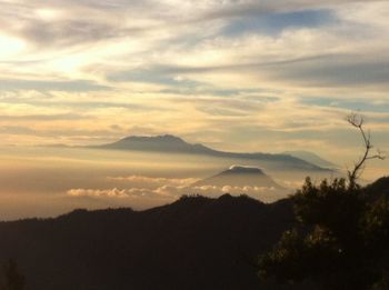 Scenic view of silhouette mountains against sky during sunset