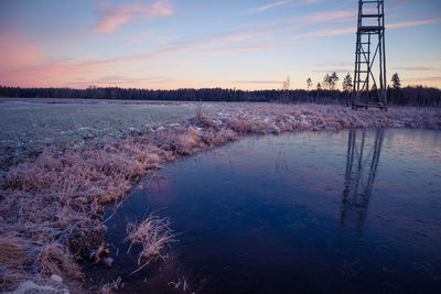 A beautiful frozen pond in the rural scene during the morning golden hour. 