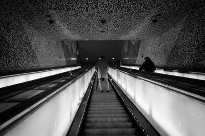 Low angle view of people moving up on escalators at subway