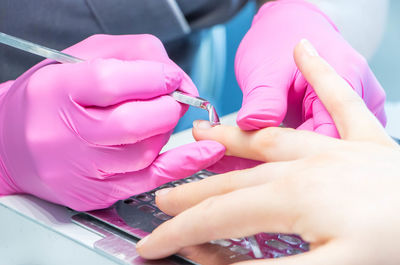 Close-up of hand giving manicure of customer