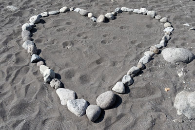 High angle view of heart shape on sand