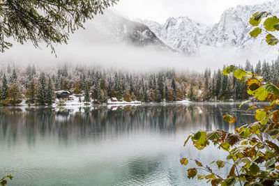 Scenic view of lake by trees against mountains