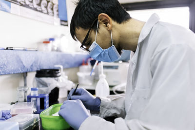 Male scientist working in the laboratory side view