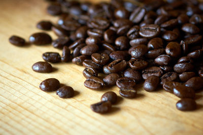 Close-up of roasted coffee beans on table