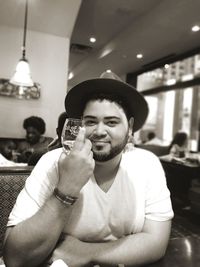 Portrait of young man sitting in restaurant