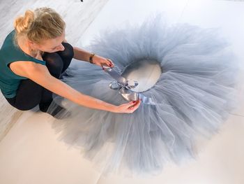 Woman tying ribbon of tutu