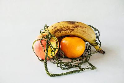 High angle view of orange fruit against white background