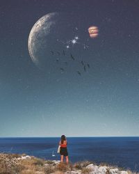 Scenic view of sea against sky at night